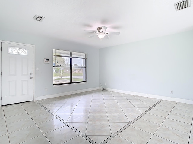 foyer with light tile patterned floors, visible vents, baseboards, and ceiling fan