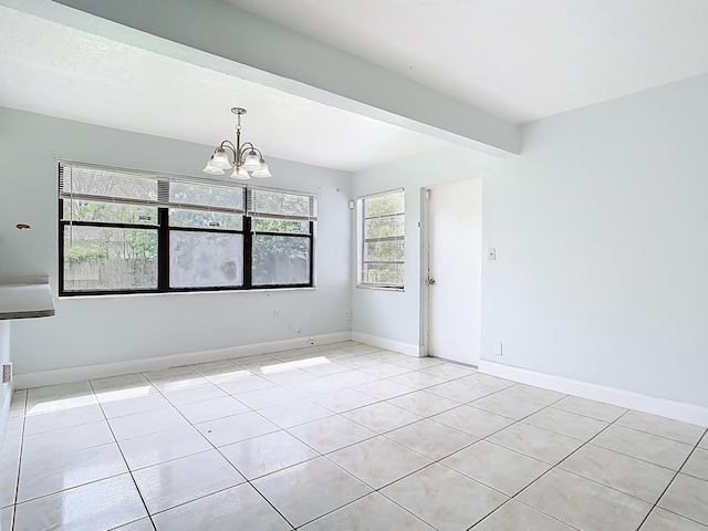 spare room with beamed ceiling, a notable chandelier, light tile patterned flooring, and baseboards