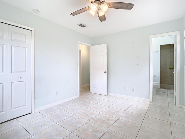 unfurnished bedroom featuring a closet, visible vents, baseboards, and light tile patterned floors