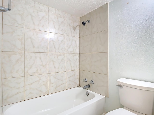 bathroom featuring toilet, a textured ceiling, shower / bathing tub combination, and a textured wall