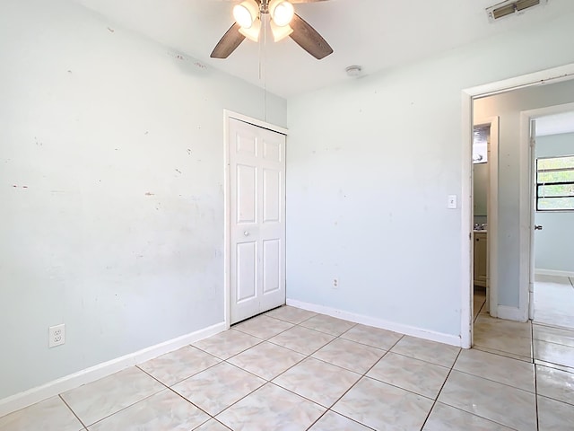 unfurnished bedroom with a closet, visible vents, and baseboards