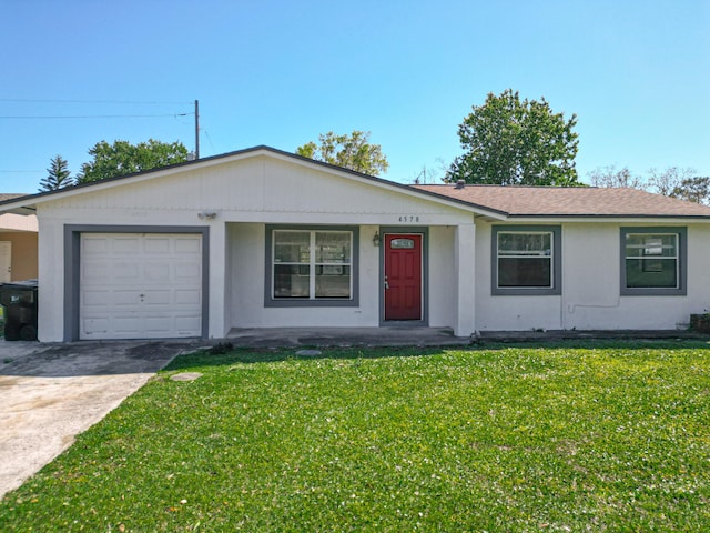 ranch-style house featuring a front lawn, an attached garage, driveway, and stucco siding