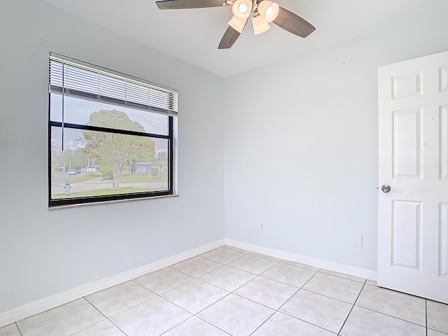 unfurnished room with light tile patterned floors, baseboards, and ceiling fan