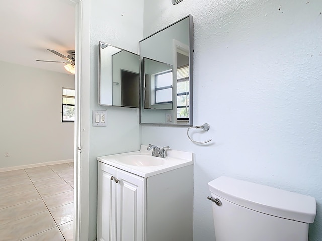 bathroom with tile patterned flooring, vanity, baseboards, and ceiling fan