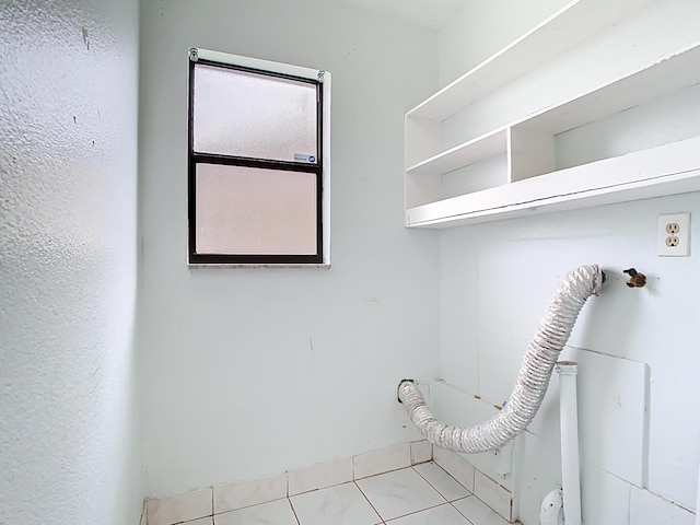 washroom with laundry area and tile patterned flooring