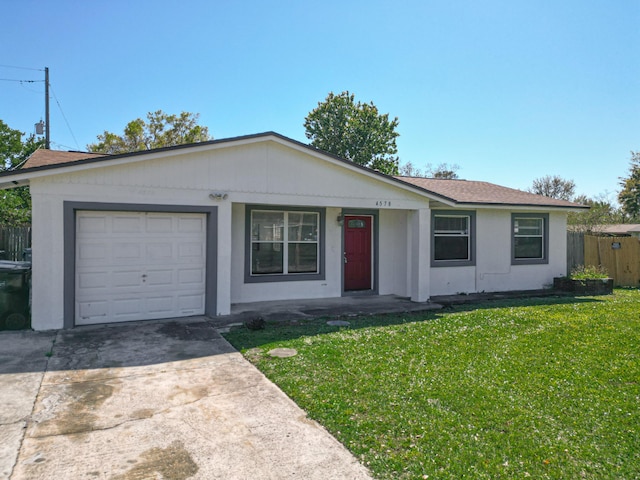 single story home featuring a front lawn, fence, concrete driveway, roof with shingles, and an attached garage