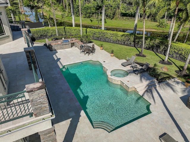 view of swimming pool with a yard, a pool with connected hot tub, a water view, a patio area, and a fenced backyard