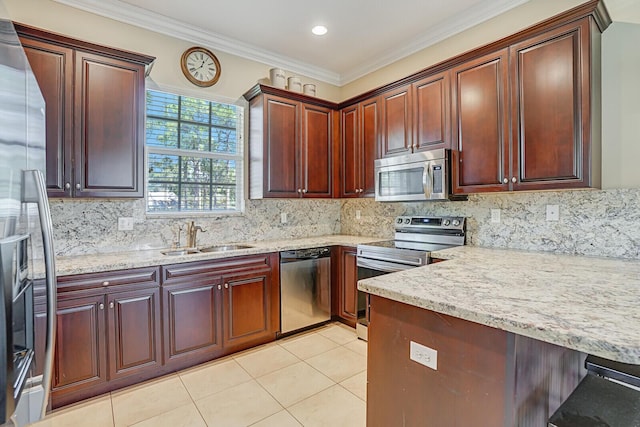 kitchen with light tile patterned floors, a sink, appliances with stainless steel finishes, ornamental molding, and decorative backsplash