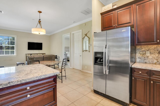 kitchen featuring light tile patterned floors, hanging light fixtures, backsplash, stainless steel fridge, and crown molding