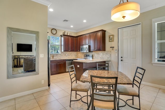 kitchen featuring visible vents, ornamental molding, light tile patterned floors, tasteful backsplash, and appliances with stainless steel finishes