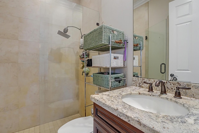 bathroom with toilet, a stall shower, and vanity