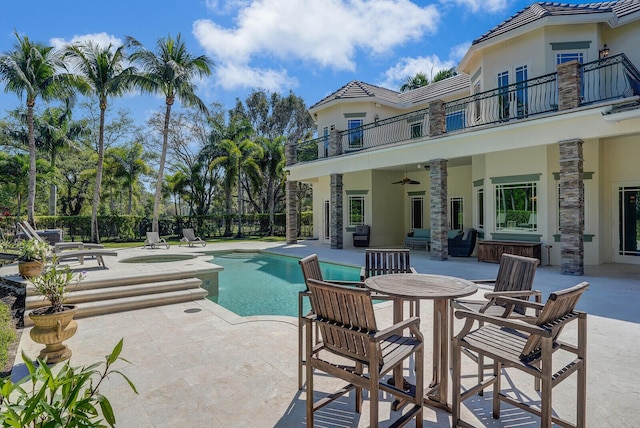 view of pool with ceiling fan, a fenced in pool, an in ground hot tub, and a patio
