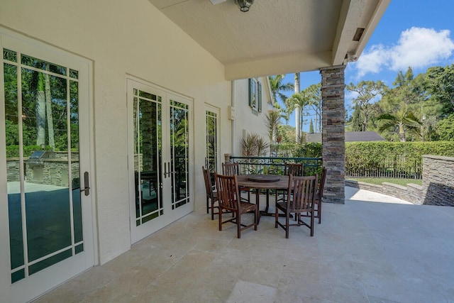 view of patio with fence, french doors, and outdoor dining space