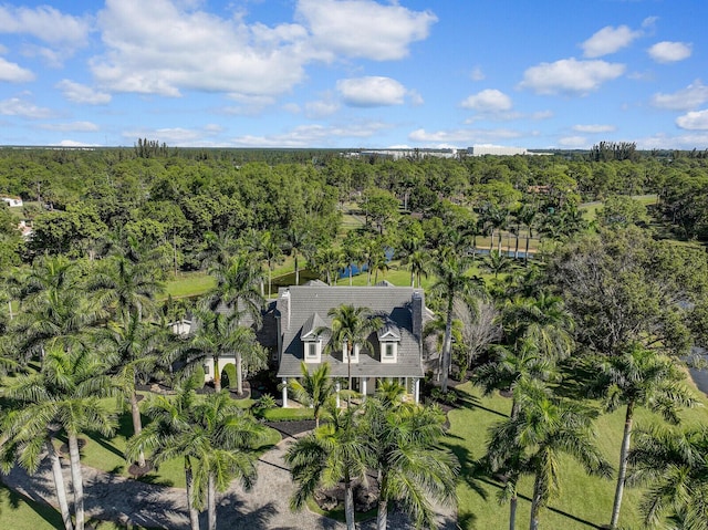 birds eye view of property featuring a wooded view