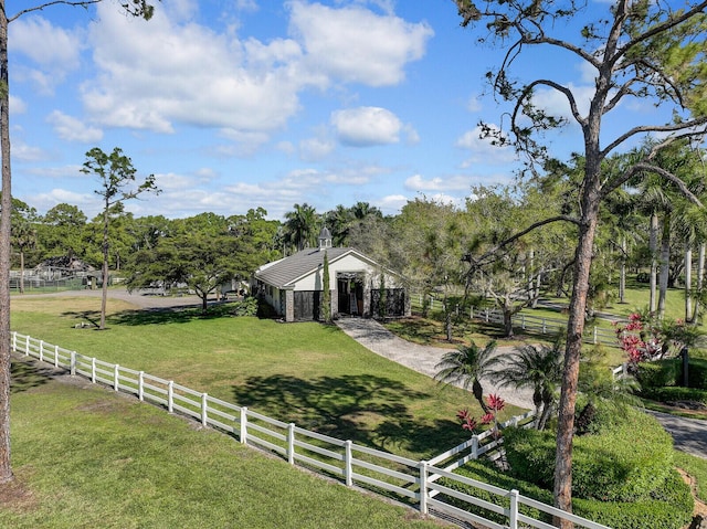 view of yard featuring fence and an outbuilding