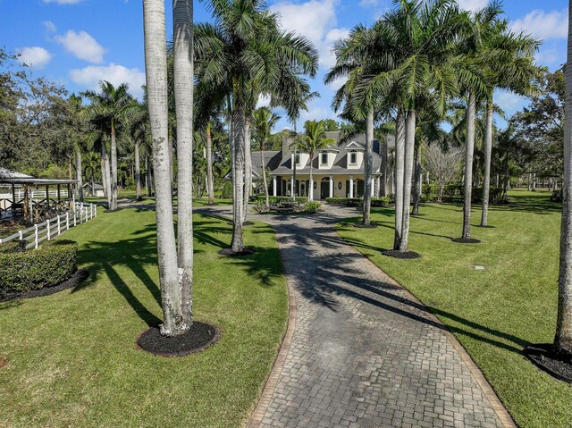 view of front of home featuring a front lawn and decorative driveway