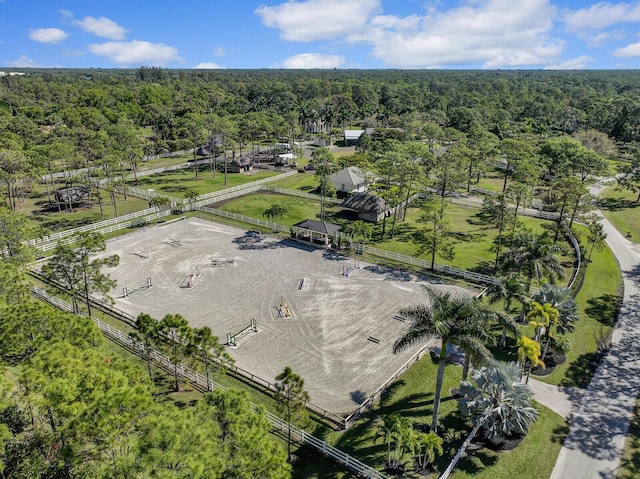 drone / aerial view with a wooded view and a rural view