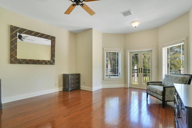 unfurnished room featuring baseboards, visible vents, dark wood-style floors, ceiling fan, and french doors