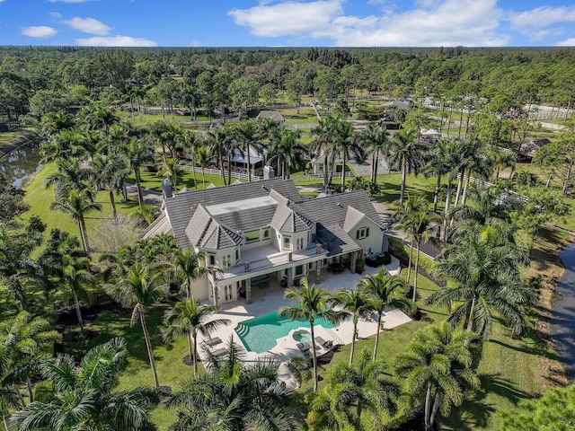 birds eye view of property with a forest view