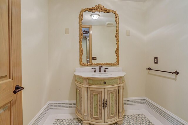 bathroom with visible vents, tile patterned floors, baseboards, and vanity