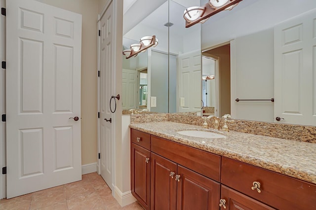 bathroom with baseboards, tile patterned flooring, and vanity