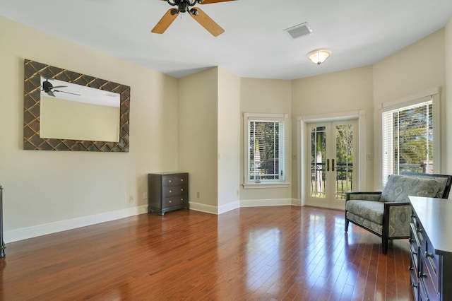 sitting room featuring ceiling fan, baseboards, wood finished floors, and visible vents