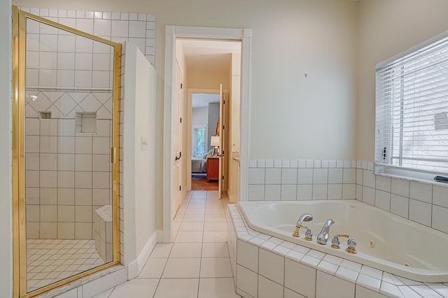 ensuite bathroom with baseboards, ensuite bath, a whirlpool tub, tile patterned flooring, and a shower stall