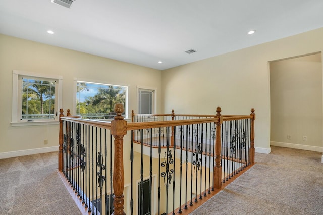 hall with baseboards, recessed lighting, visible vents, and carpet