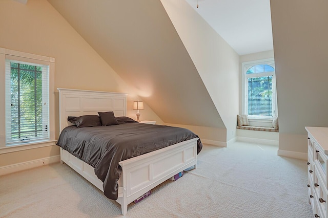 bedroom with light carpet, baseboards, and lofted ceiling