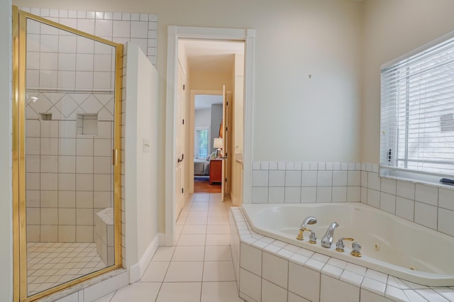 full bathroom featuring a stall shower, baseboards, a whirlpool tub, tile patterned flooring, and ensuite bath