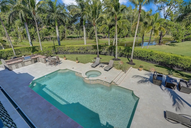 outdoor pool with an in ground hot tub, a yard, a patio, and a water view