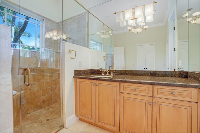 full bath featuring a chandelier, a shower stall, vanity, and ornamental molding