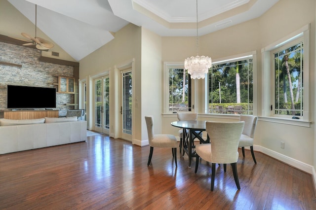 dining room featuring high vaulted ceiling, a healthy amount of sunlight, visible vents, and hardwood / wood-style floors