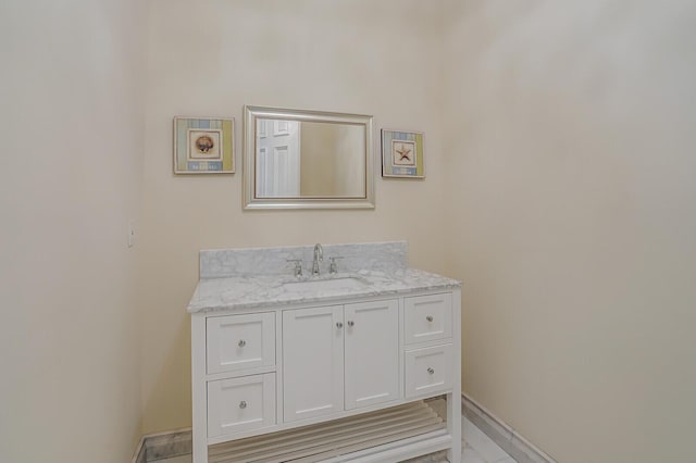 bathroom with baseboards and vanity