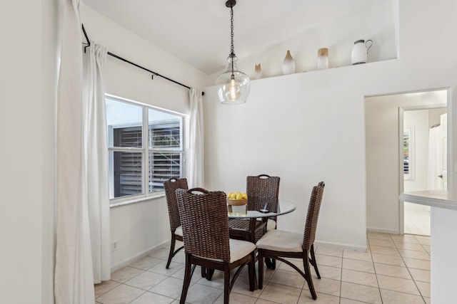 dining area with baseboards and light tile patterned flooring