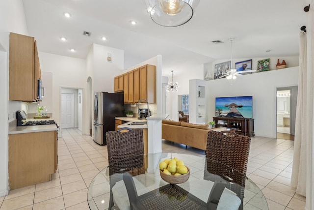 kitchen with light tile patterned flooring, visible vents, open floor plan, light countertops, and appliances with stainless steel finishes