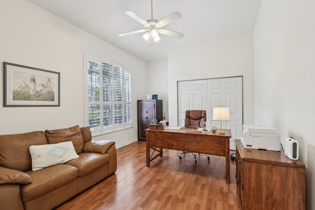 office with vaulted ceiling, baseboards, ceiling fan, and light wood finished floors