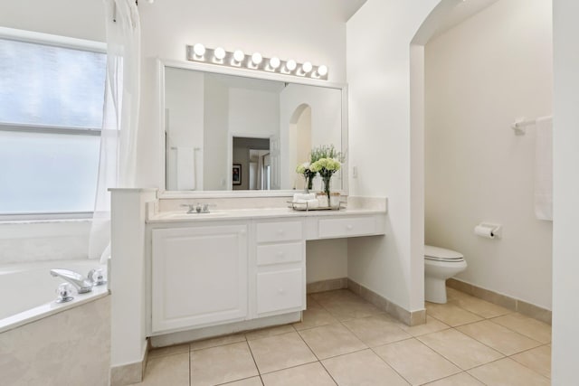 full bath featuring baseboards, toilet, tile patterned floors, vanity, and a bath