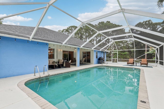 pool featuring a lanai, a patio area, and outdoor lounge area