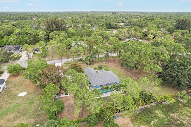 birds eye view of property with a view of trees