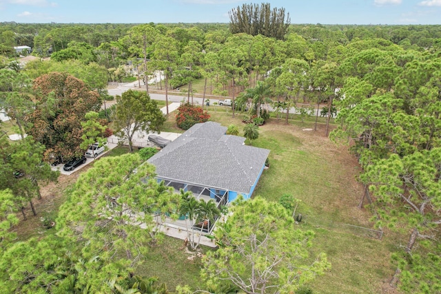 birds eye view of property with a forest view