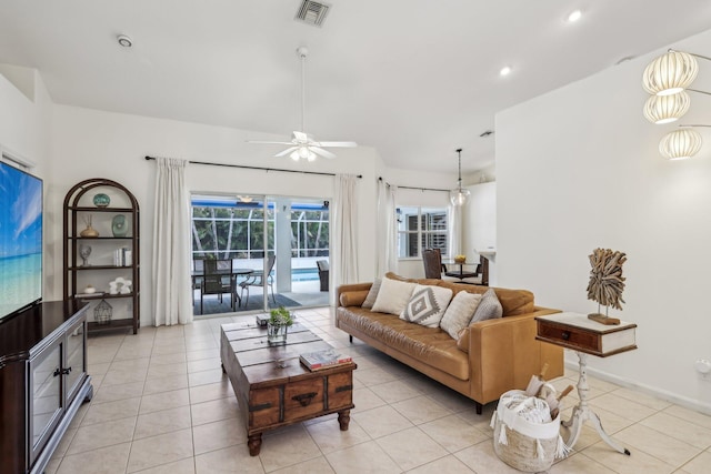 living area featuring light tile patterned floors, ceiling fan, recessed lighting, visible vents, and baseboards