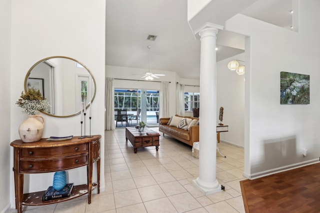 living area featuring ornate columns, ceiling fan, light tile patterned floors, and visible vents