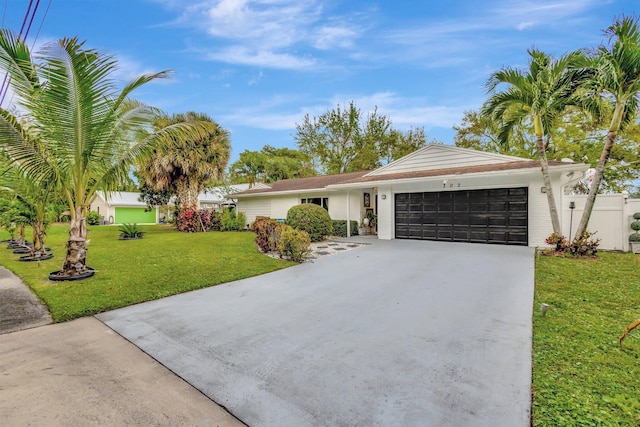 ranch-style house with a front yard, driveway, and an attached garage