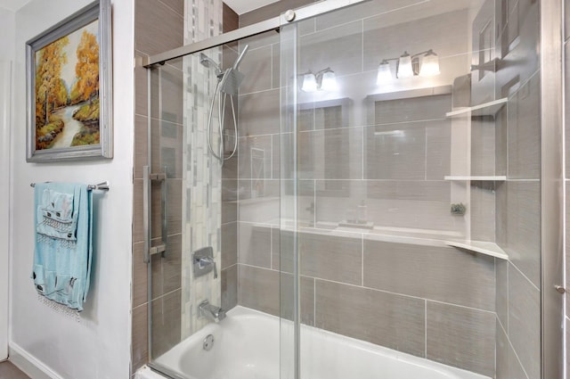 bathroom with shower / bath combination with glass door