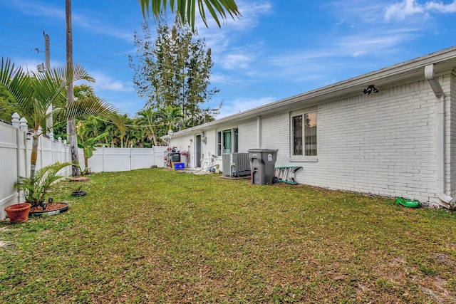 view of yard with a fenced backyard and cooling unit