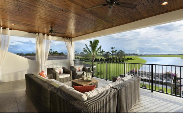 exterior space featuring a water view, ceiling fan, and an outdoor living space