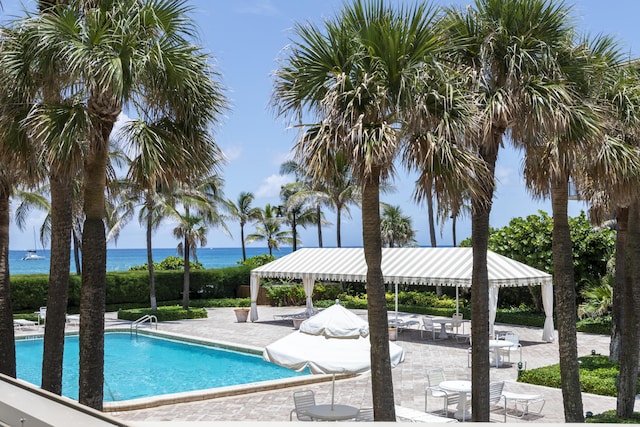 pool with a water view and a patio area