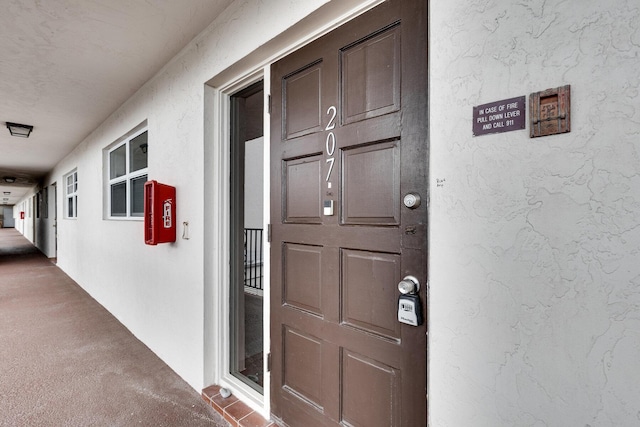 entrance to property with stucco siding