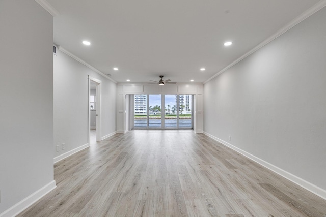 spare room featuring baseboards, ceiling fan, ornamental molding, light wood-style floors, and recessed lighting